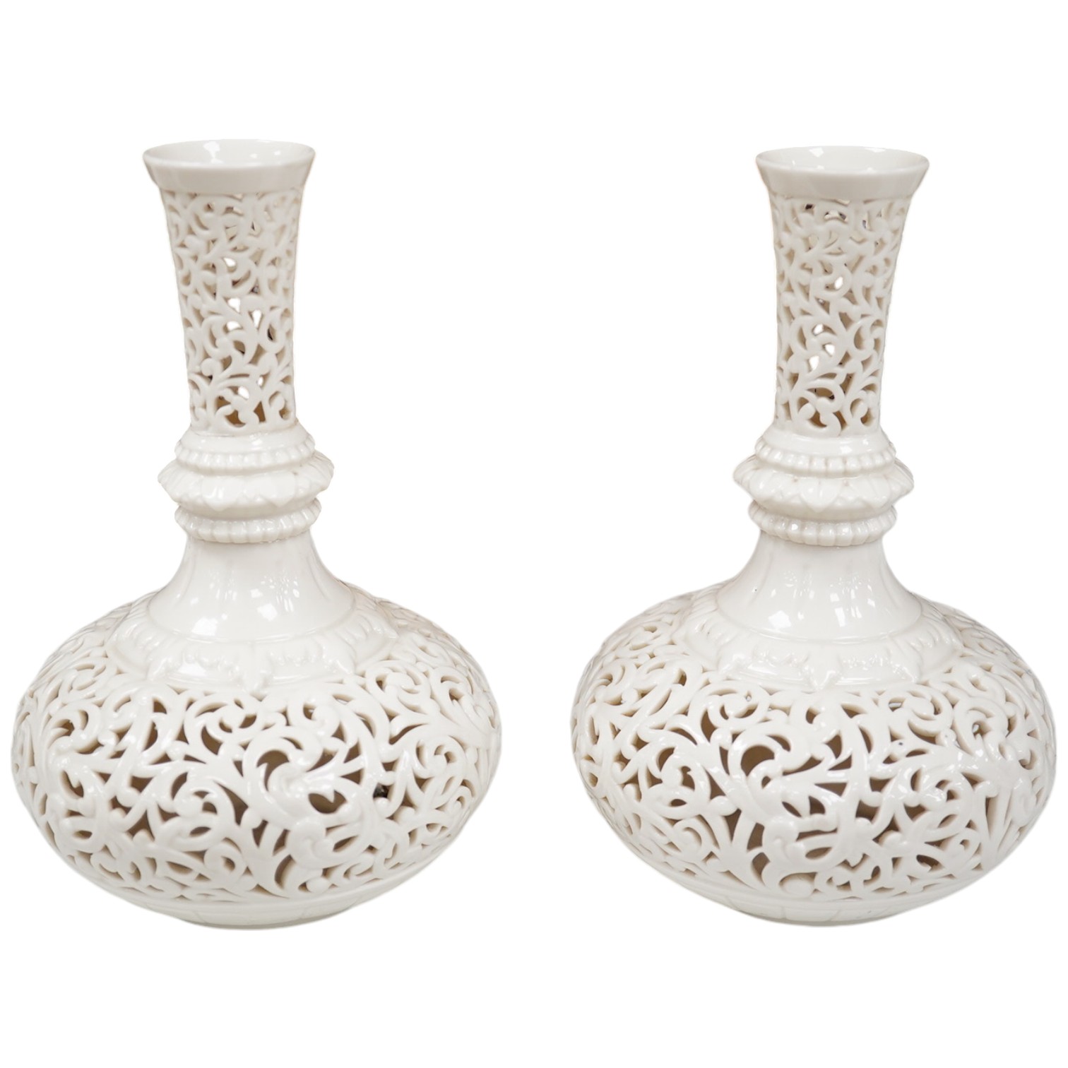 A pair of unsigned Worcester style reticulated vases, 18cm high. Condition - one repaired at neck